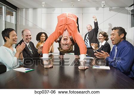Businesswoman doing backbend at meeting View Large Photo Image Stock Photograph - Businesswoman doing backbend at meeting. Fotosearch