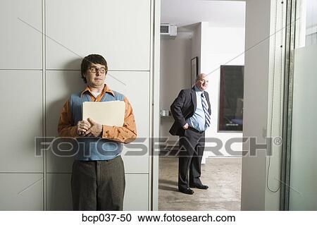 Employee hiding from the boss View Large Photo Image Stock Image - Employee hiding from the boss. Fotosearch