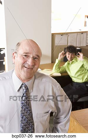 Employee making fun of boss View Large Photo Image Stock Photograph - Employee making fun of boss. Fotosearch