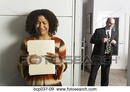 Geeky man pursuing female co-worker View Large Photo Image Stock Photo - Geeky man pursuing female co-worker. Fotosearch