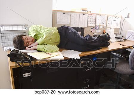 Man Asleep On His Desk Stock Image Bcp037 20 Fotosearch