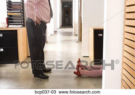 Office worker discovering prone female body View Large Photo Image Stock Image - Office worker discovering prone female body. Fotosearch