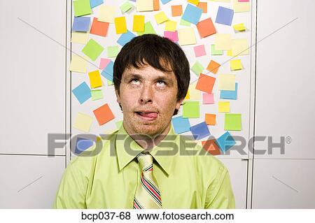 Office worker making a silly face View Large Photo Image Stock Photo - Office worker making a silly face. Fotosearch