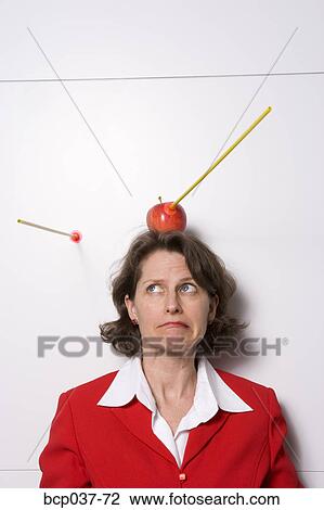 Shooting apple off businesswoman's head View Large Photo Image Stock Image - Shooting apple off businesswoman's head. Fotosearch