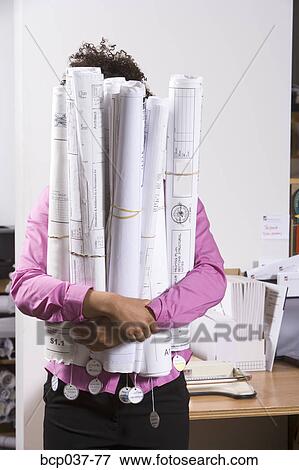 Woman holding bundle of blueprints View Large Photo Image Stock Photo - Woman holding bundle of blueprints. Fotosearch