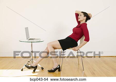 Picture - Contemplative woman with laptop. Fotosearch