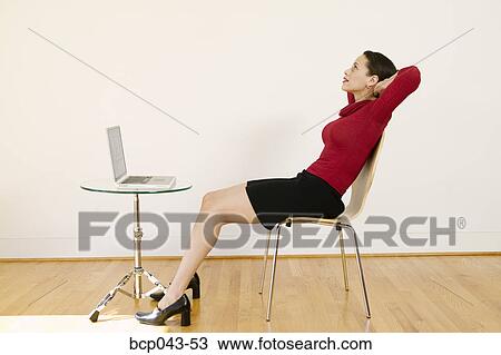 Stock Image - Contemplative woman with laptop. Fotosearch