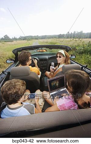 Family in convertible using portable electronics View Large Photo Image Stock Image - Family in convertible using portable electronics. Fotosearch