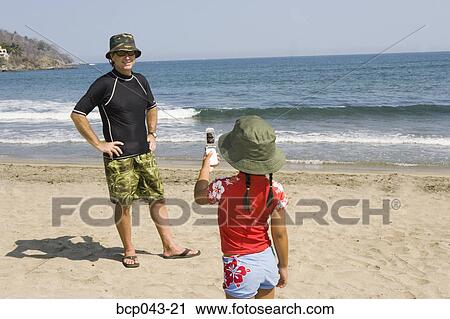 Girl taking picture of dad with phone View Large Photo Image Stock Image - Girl taking picture of dad with phone. Fotosearch