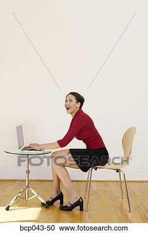 Laughing woman using laptop View Large Photo Image Stock Image - Laughing woman using laptop. Fotosearch