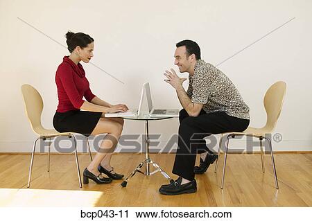 Man and woman with laptops View Large Photo Image Stock Image - Man and woman with laptops. Fotosearch
