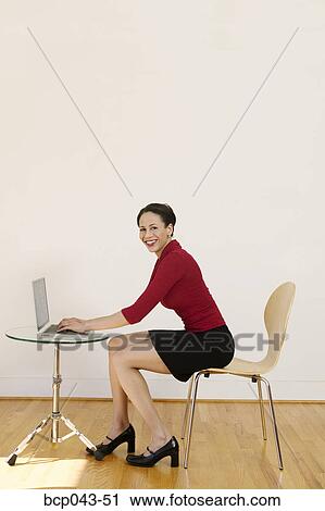 Stock Image - Portrait of woman using laptop. Fotosearch