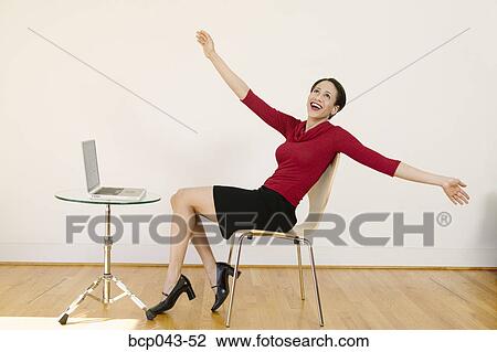 Stock Image - Relieved woman with laptop. Fotosearch