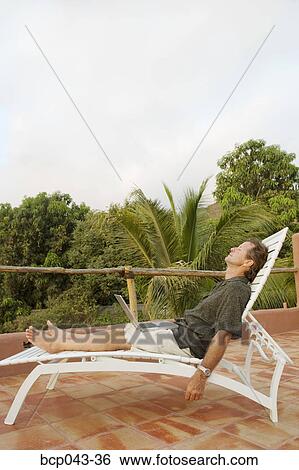 Sunbathing man asleep with laptop View Large Photo Image Stock Photograph - Sunbathing man asleep with laptop. Fotosearch
