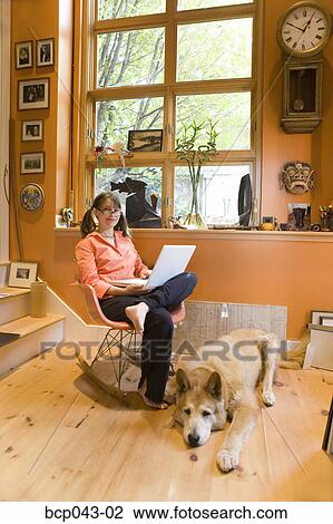 Woman using laptop at home View Large Photo Image Stock Image - Woman using laptop at home. Fotosearch