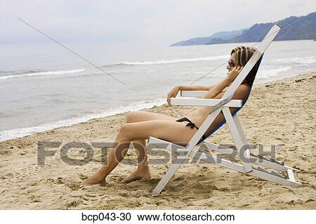 Woman using mobile phone at beach View Large Photo Image Stock Image - Woman using mobile phone at beach. Fotosearch