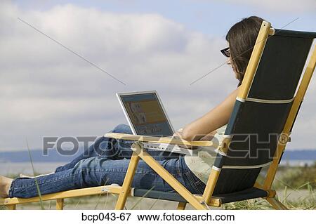 Young woman with laptop on beach View Large Photo Image Stock Photo - Young woman with laptop on beach. Fotosearch