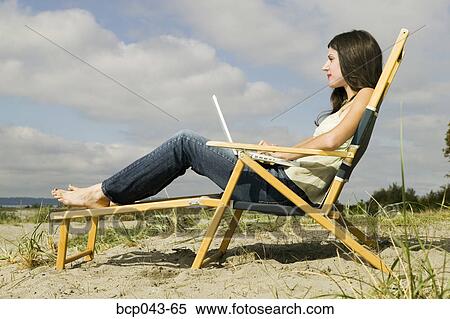 Young woman with laptop on beach View Large Photo Image Stock Photography - Young woman with laptop on beach. Fotosearch