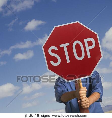 Stock Photograph - Man holding a stop signboard. Fotosearch