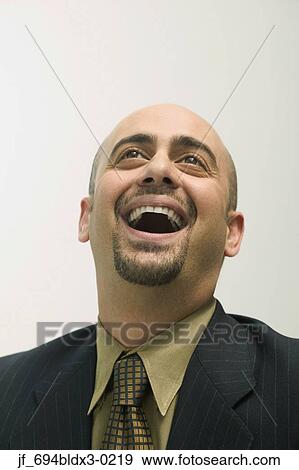 Stock Photo - Mid adult man laughing. Fotosearch