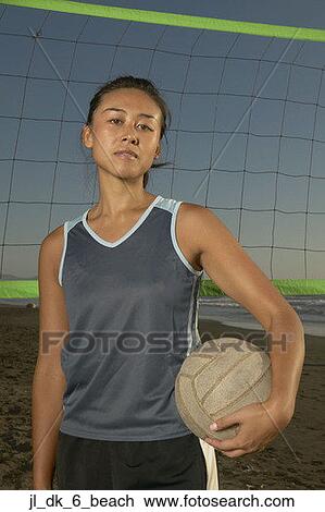 Portrait of a young woman holding a volley in front of a net View Large Photo Image Stock Image - Portrait of a young woman holding a volley in front of a net. Fotosearch
