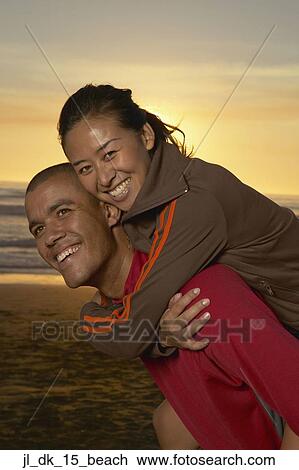 Portrait of a young woman riding piggyback on a young man View Large Photo Image Stock Image - Portrait of a young woman riding piggyback on a young man. Fotosearch