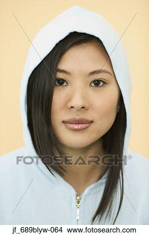 Teenage girl wearing a hooded jacket looking at camera smiling View Large Photo Image Picture - Teenage girl wearing a hooded jacket looking at camera smiling. Fotosearch