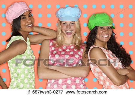 Three young women looking at camera smiling View Large Photo Image Stock Photo - Three young women looking at camera smiling. Fotosearch