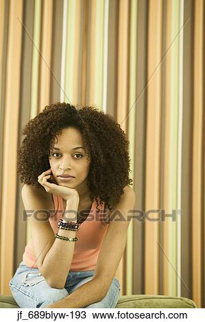 Woman sitting looking at camera View Large Photo Image Stock Image - Woman sitting looking at camera. Fotosearch