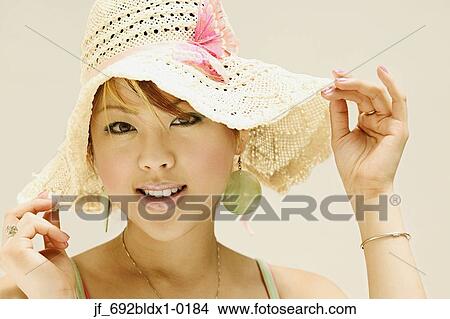 Picture - Woman wearing a hat looking at camera . Fotosearch