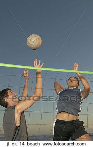 Young couple playing volleyball View Large Photo Image Stock Image - Young couple playing volleyball. Fotosearch