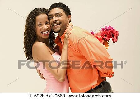 Young couple standing together looking at camera smiling View Large Photo Image Stock Photo - Young couple standing together looking at camera smiling. Fotosearch