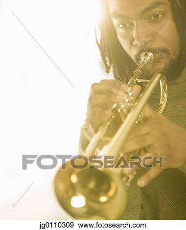 Young man playing a trumpet View Large Photo Image Stock Photo - Young man playing a trumpet. Fotosearch