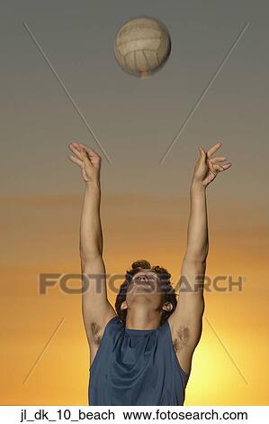 Stock Image - Young man playing volleyball. Fotosearch