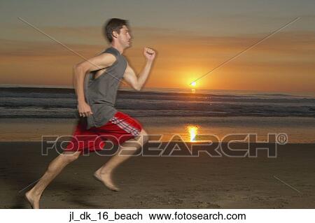 Young man running on the beach View Large Photo Image Stock Image - Young man running on the beach. Fotosearch