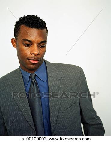 A mid adult businessman looking down View Large Photo Image Stock Image - A mid adult businessman looking down. Fotosearch