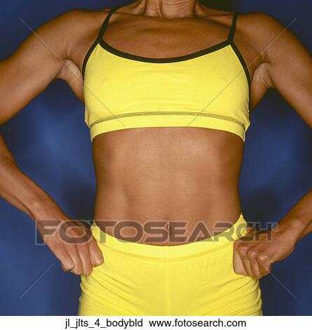 Stock Image - Close-up of a the torso of a muscular young woman. Fotosearch