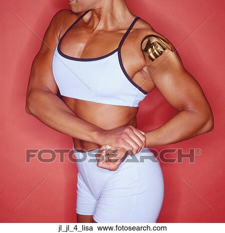Close-up of a young woman flexing her muscles View Large Photo Image Stock Image - Close-up of a young woman flexing her muscles. Fotosearch