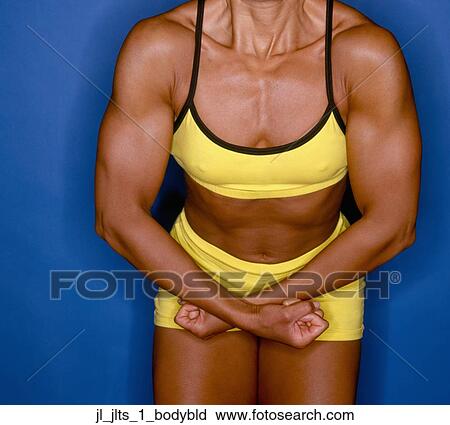 Close-up of a young woman flexing her muscles View Large Photo Image Stock Image - Close-up of a young woman flexing her muscles. Fotosearch