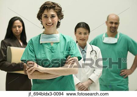 Picture - Group of doctors looking at camera smiling. Fotosearch