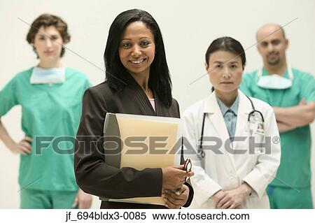 Group of doctors looking at camera smiling View Large Photo Image Stock Photography - Group of doctors looking at camera smiling. Fotosearch
