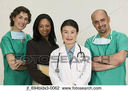 Stock Image - Group of doctors looking at looking at camera smiling. Fotosearch
