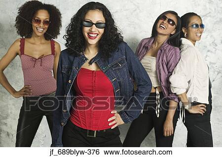 Group of young woman standing together looking at camera smiling View Large Photo Image Stock Photograph - Group of young woman standing together looking at camera smiling. Fotosearch