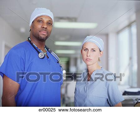 Male and female nurse standing in a hospital corridor View Large Photo Image Stock Photography - Male and female nurse standing in a hospital corridor. Fotosearch