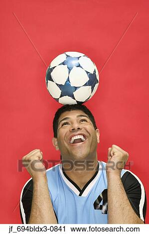 Man balancing a football on his head View Large Photo Image Stock Image - Man balancing a football on his head. Fotosearch