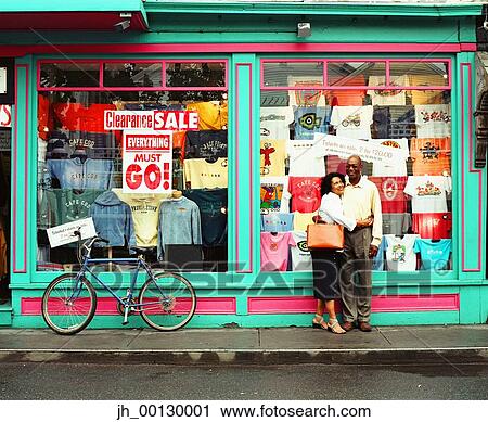Mature couple standing in front of a clothing store View Large Photo Image Stock Image - Mature couple standing in front of a clothing store. Fotosearch