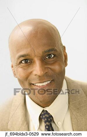 Portrait of a businessman looking at camera smiling View Large Photo Image Stock Photo - Portrait of a businessman looking at camera smiling. Fotosearch