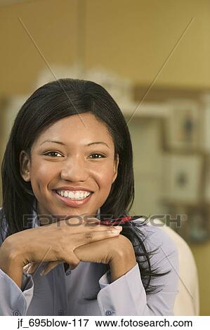 Portrait of a businesswoman looking at camera smiling View Large Photo Image Stock Photo - Portrait of a businesswoman looking at camera smiling. Fotosearch