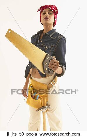Portrait of a young woman holding a saw View Large Photo Image Stock Image - Portrait of a young woman holding a saw. Fotosearch