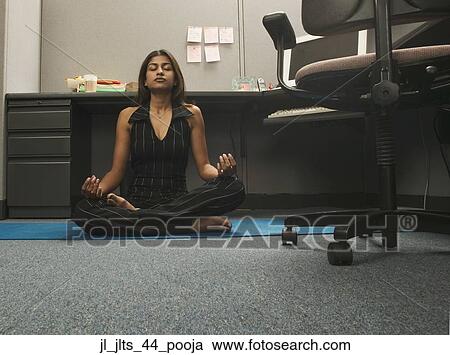 Portrait of a young woman meditating on the floor of an office View Large Photo Image Stock Image - Portrait of a young woman meditating on the floor of an office. Fotosearch